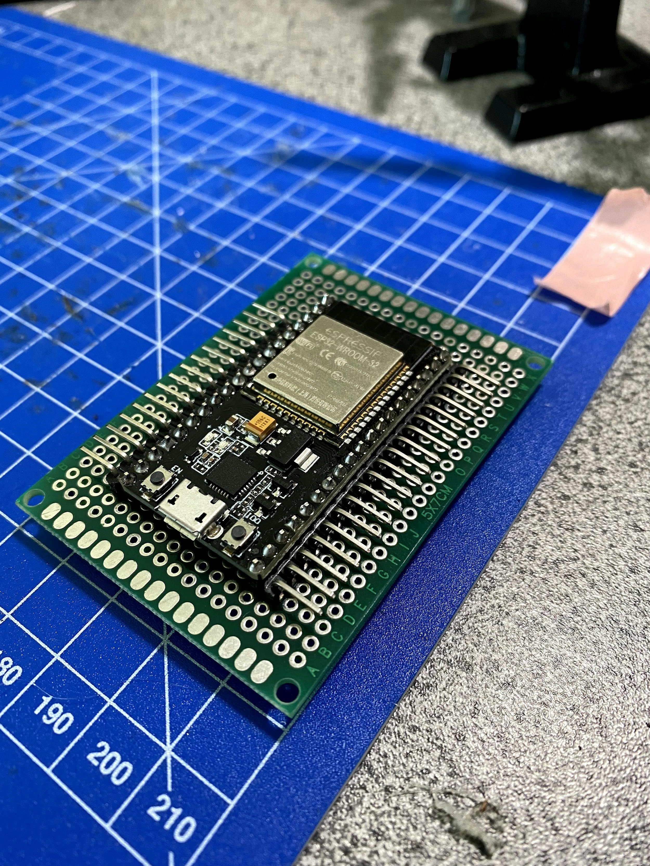 ESP32 soldered to protoboard with some male headers to connect inputs to.